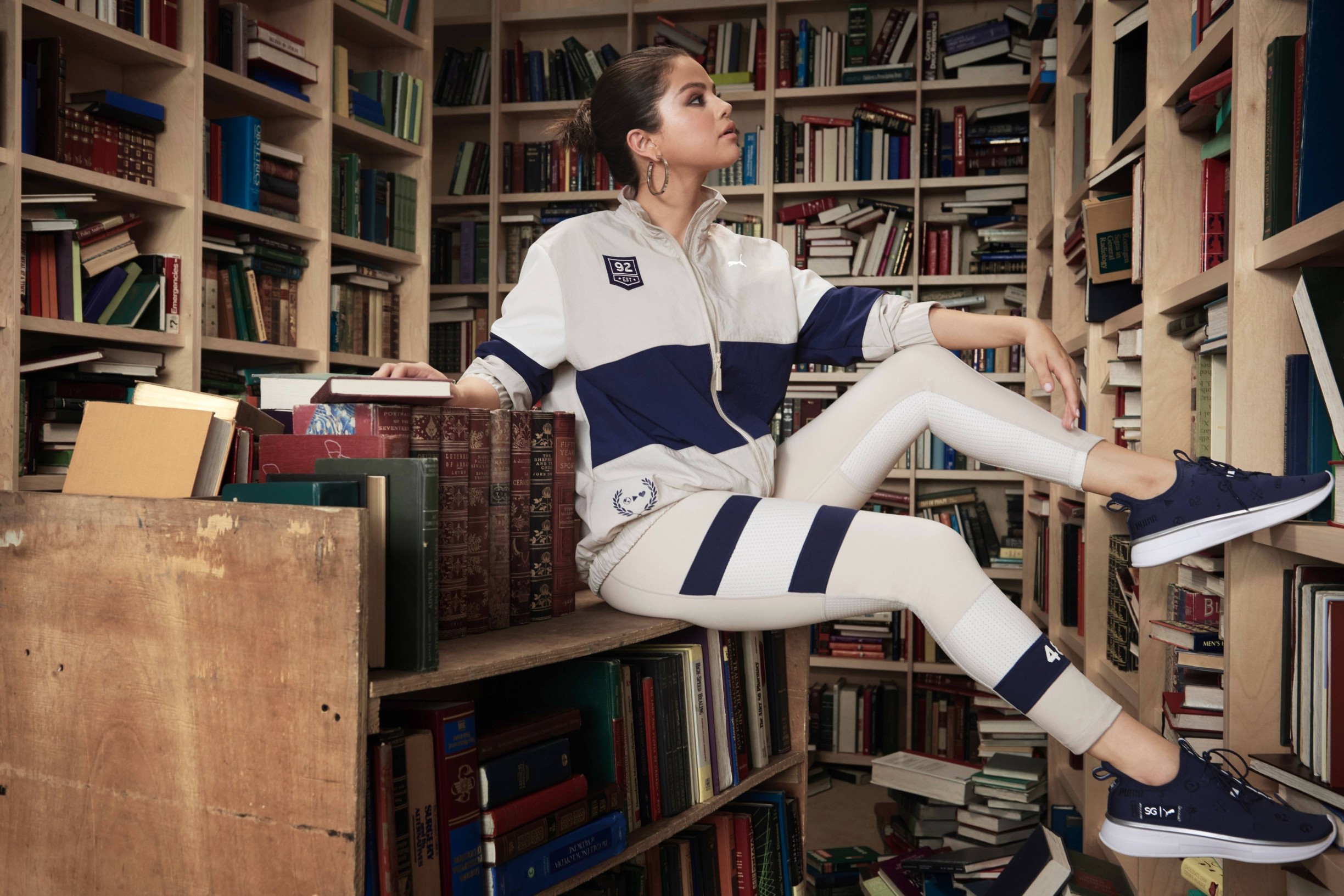 Selena Gomez shows off her literary side - as she balances a book on her head in a fashion campaign.
The singer, 27, showcases a new collection from sportswear giant, Puma - and poses among stacks of textbooks  
The new SG x PUMA line is described as a 